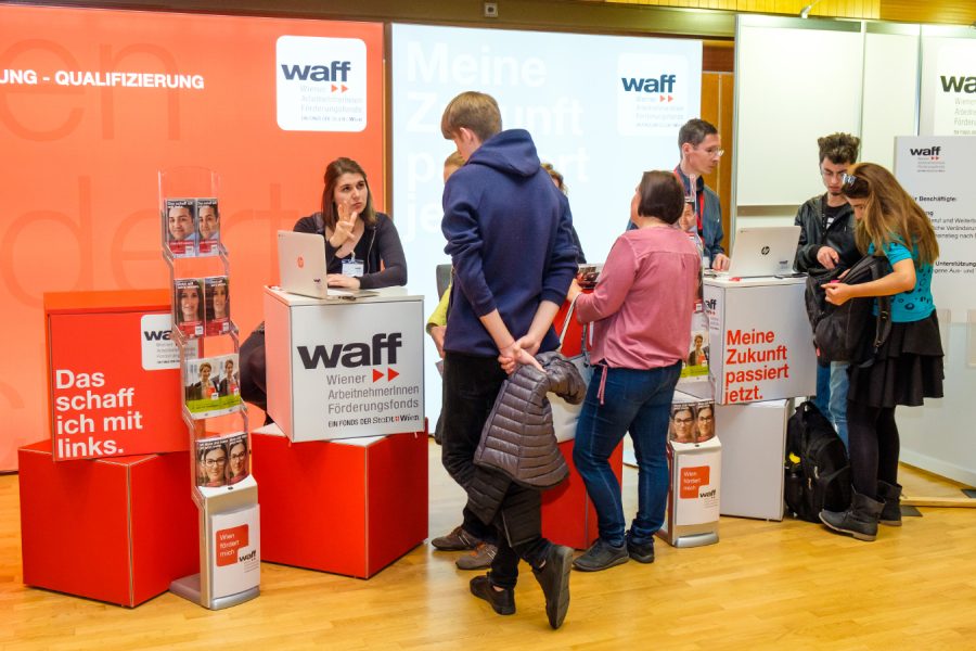 Menschen vor einem Infostand.